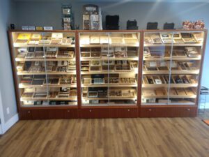 A room filled with shelves of different types of cigars.